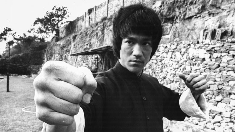 Bruce Lee en tenue noire, poings levés